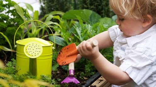 Boy in childcare centre gardening outside